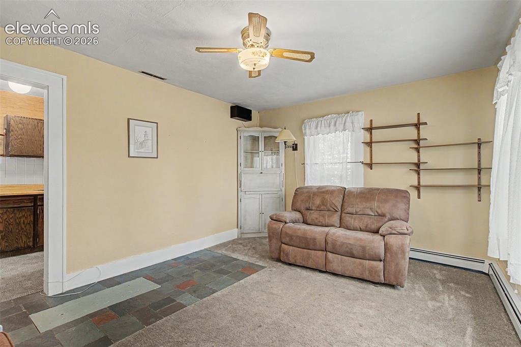 Image 7 of 26: View of living room to kitchen entry
