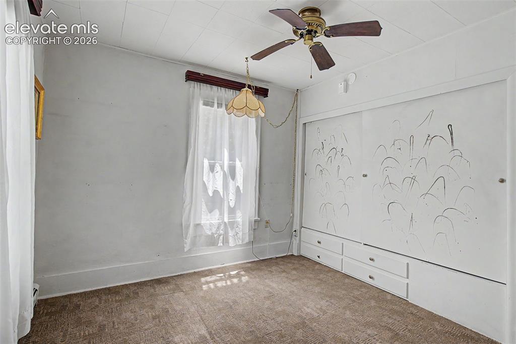 Image 9 of 26: Primary bedroom - wall of closets