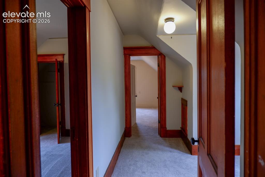 Image 21 of 38: upstairs hallway to rooms, bathroom, and sunlit reading nook