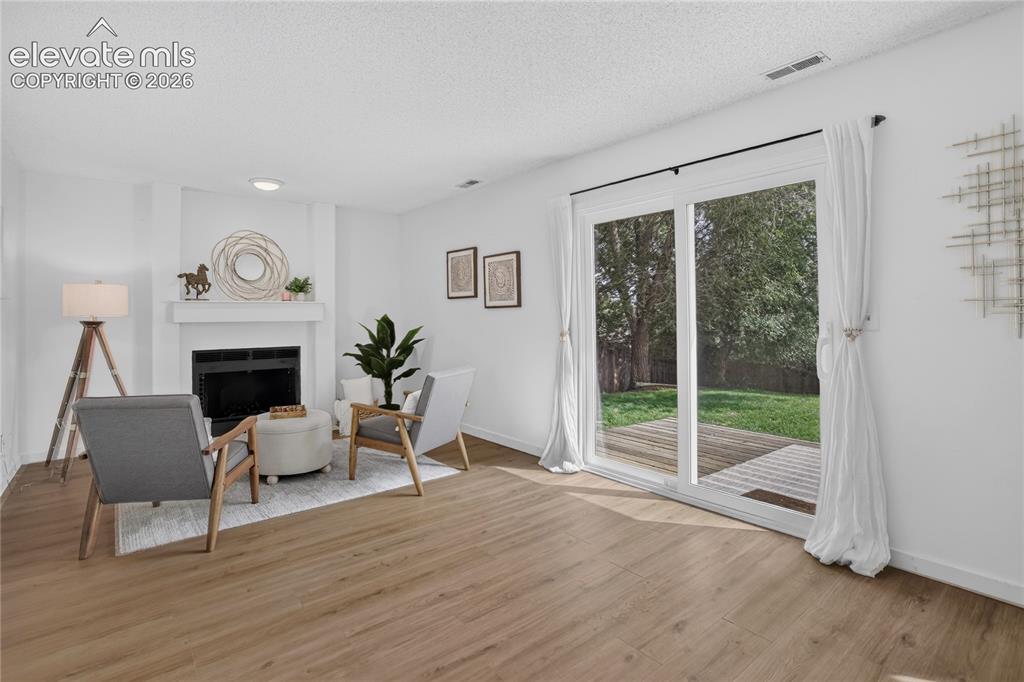 Image 18 of 25: Walk-out family room w/ fireplace