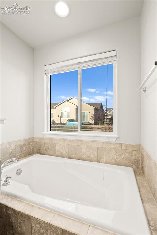 Image 15 of 48: Primary Bathtub BathRoom /Bed Main Floor Bathtub