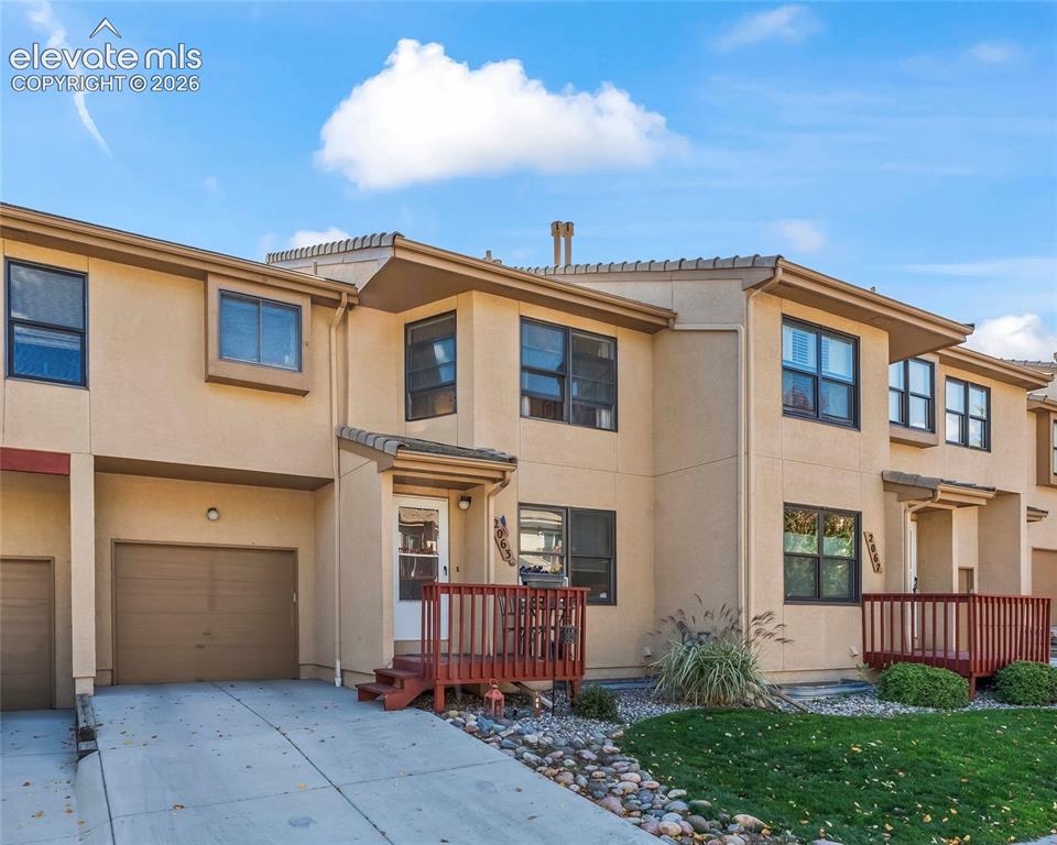 Image 1 of 43: Multi-level townhouse with stucco exterior, attached garage, private entry