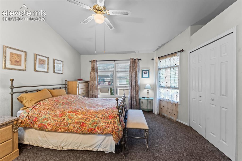 Image 15 of 43: Vaulted ceiling with a ceiling fan, dual windows, and bifold closet doors