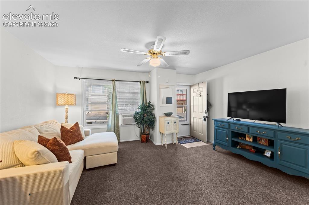 Image 2 of 43: Textured carpeting, white walls, and a ceiling fan with integrated lighting
