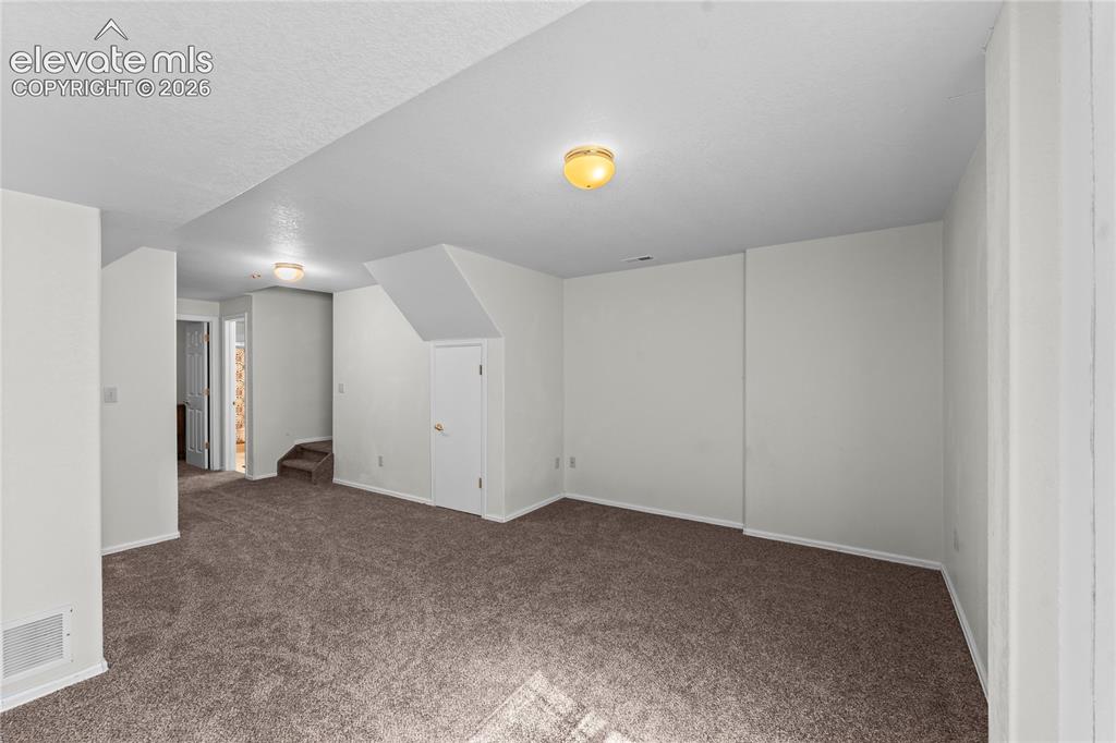 Image 25 of 43: Open floor plan with plush carpeting