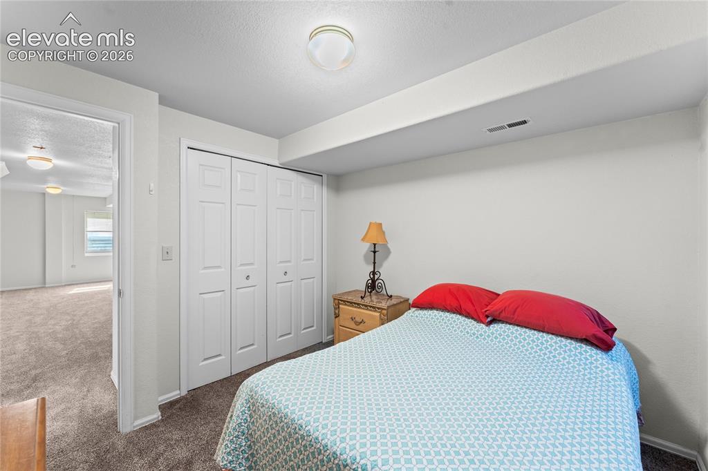 Image 28 of 43: Neutral wall paint, recessed lighting, bi-fold closet doors, and carpet flo