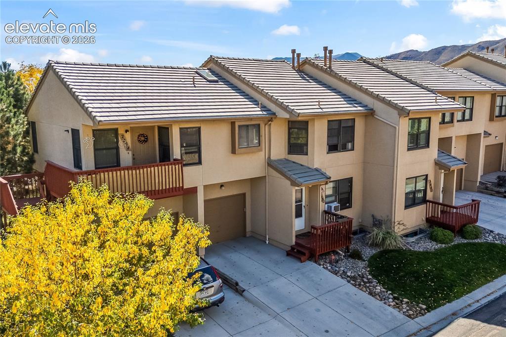 Image 34 of 43: Stucco exterior with a tile roof, an upper-level balcony, a ground-level de