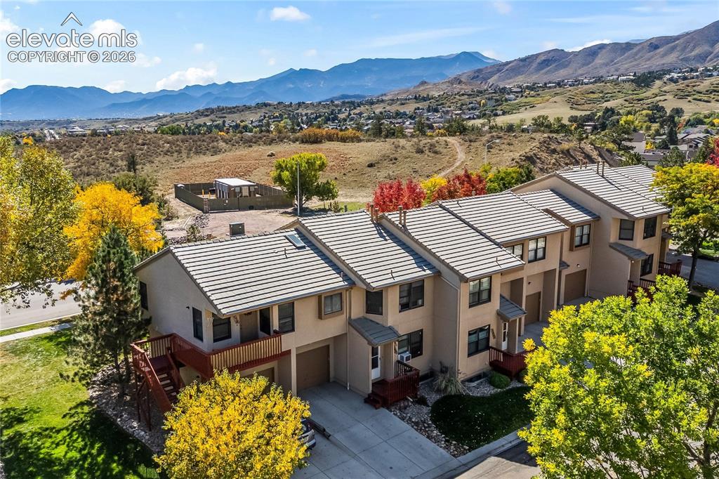 Image 35 of 43: Terraced townhome-style residences with attached garages and tile roofing