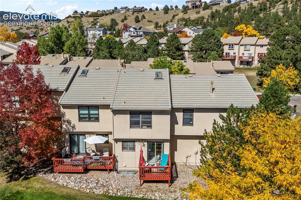 Image 38 of 43: Multi-level townhome featuring a tiled roof, multiple skylights, and a priv