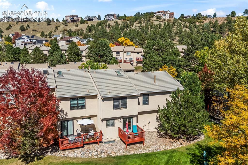 Image 39 of 43: Terraced landscaping with two private decks, skylights, stucco exterior, an