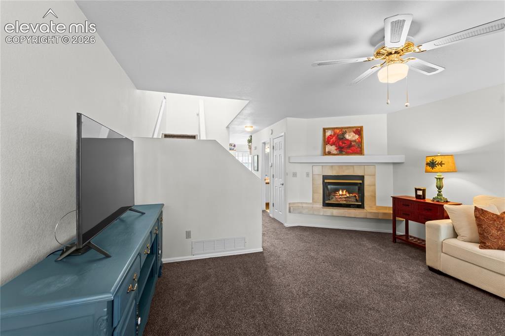 Image 5 of 43: Built-in fireplace with tile surround and mantel