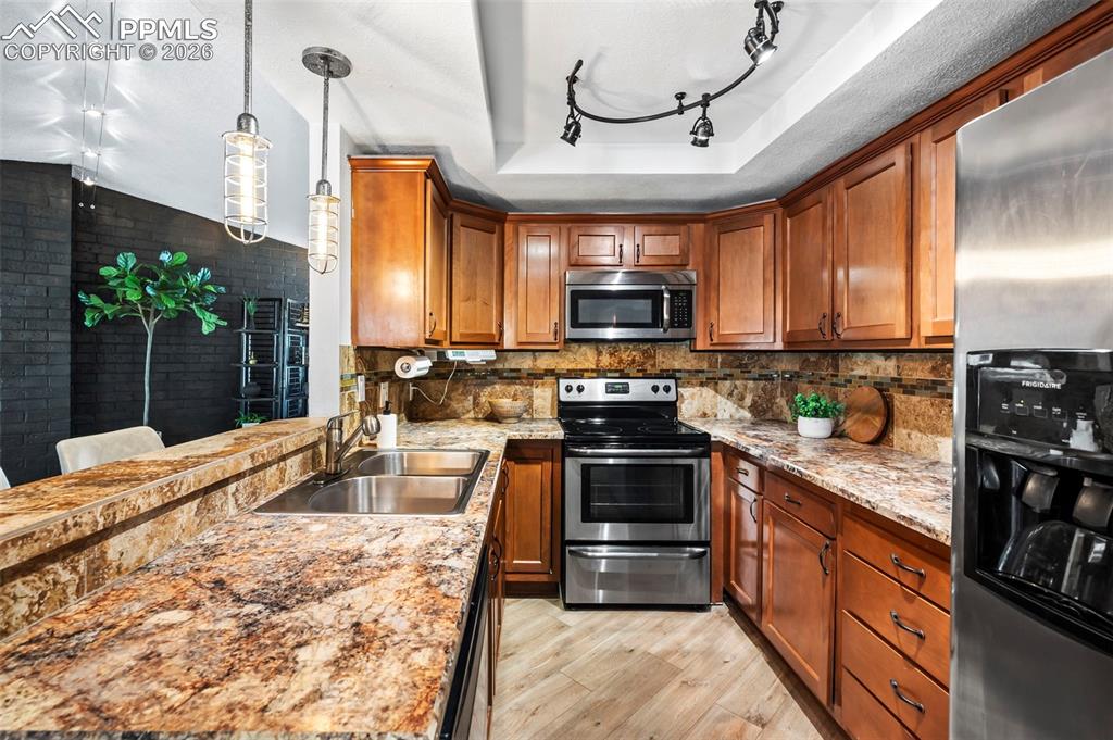 Image 13 of 39: Rich wood cabinetry brings warmth, depth, and a sense of timeless craftsman