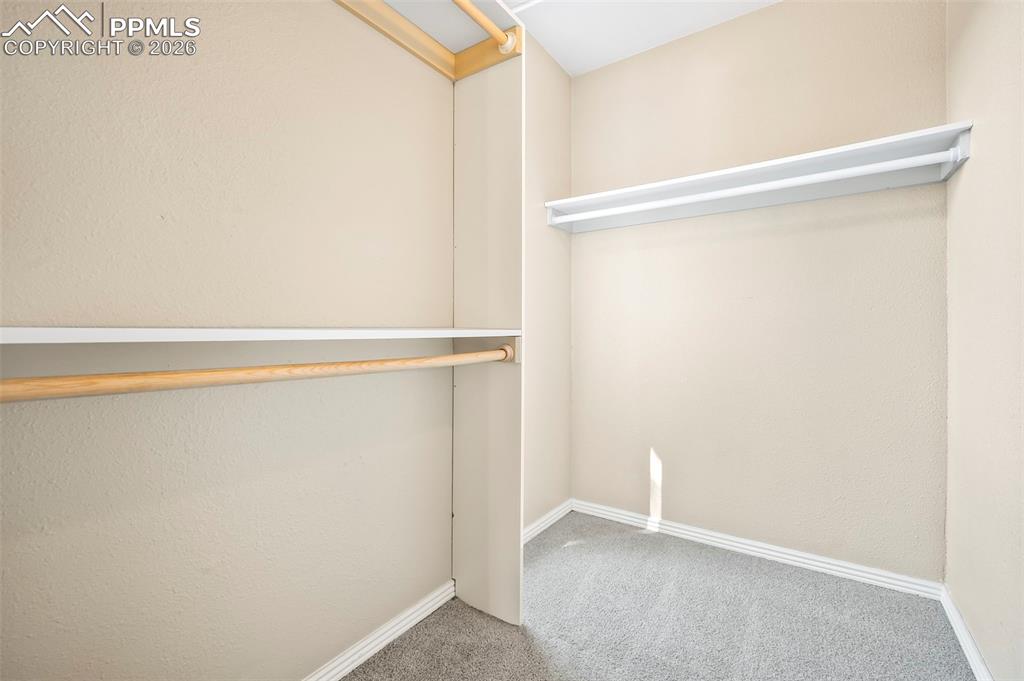 Image 18 of 39: Spacious Primary Walk-in Closet