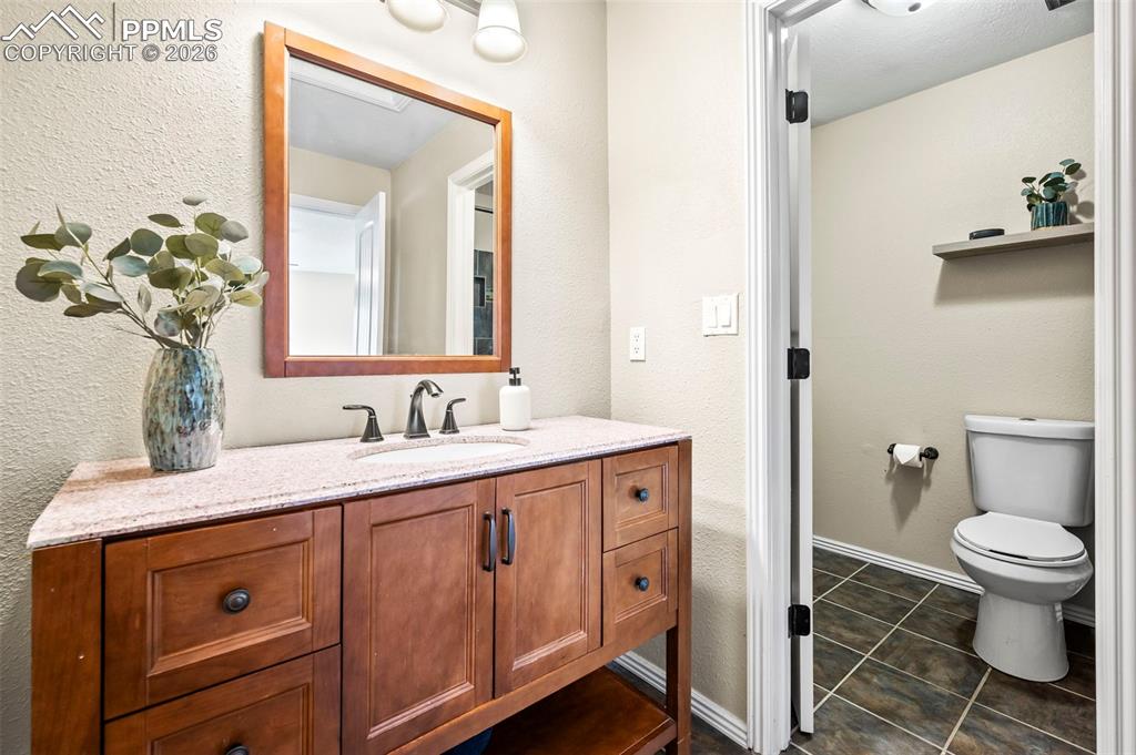 Image 19 of 39: Private Primary Ensuite with updated vanity w/granite countertop, tile floo