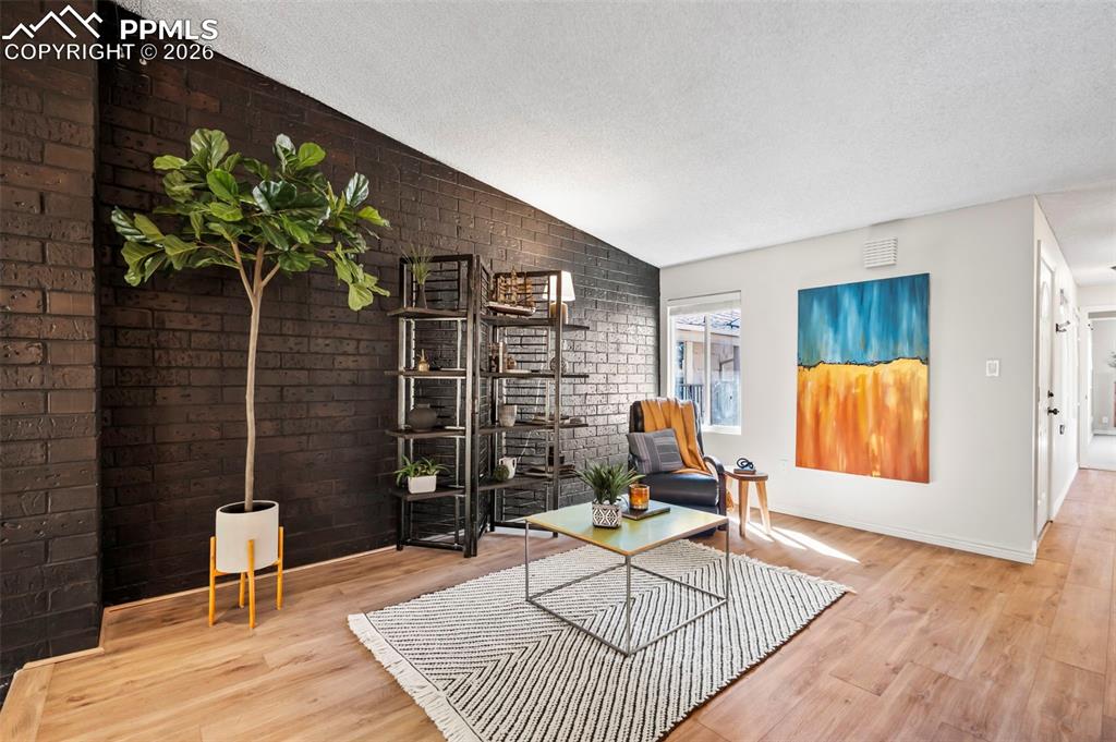 Image 4 of 39: Sunlit open bonus living area ideal for a home office, reading lounge, well