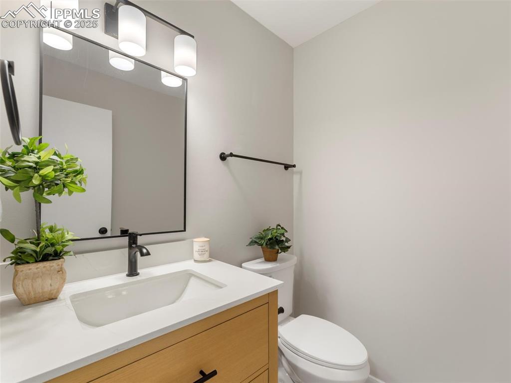 Image 15 of 36: Half bathroom featuring new vanity and toilet