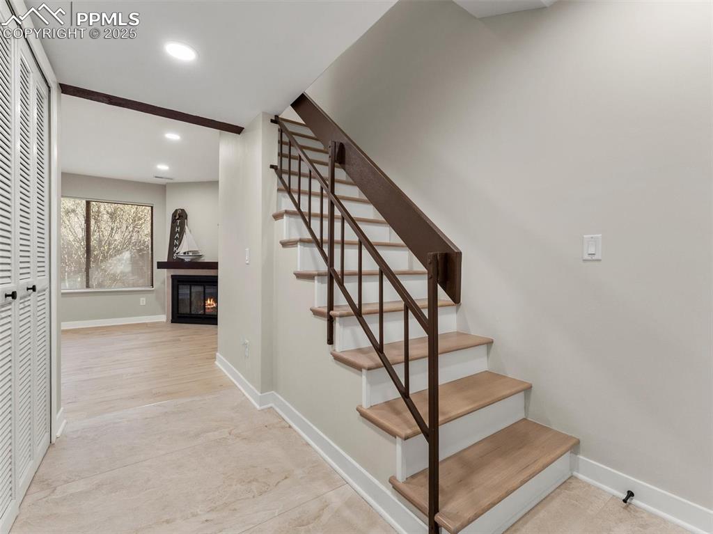 Image 3 of 36: Wood plank laminate flooring throughout