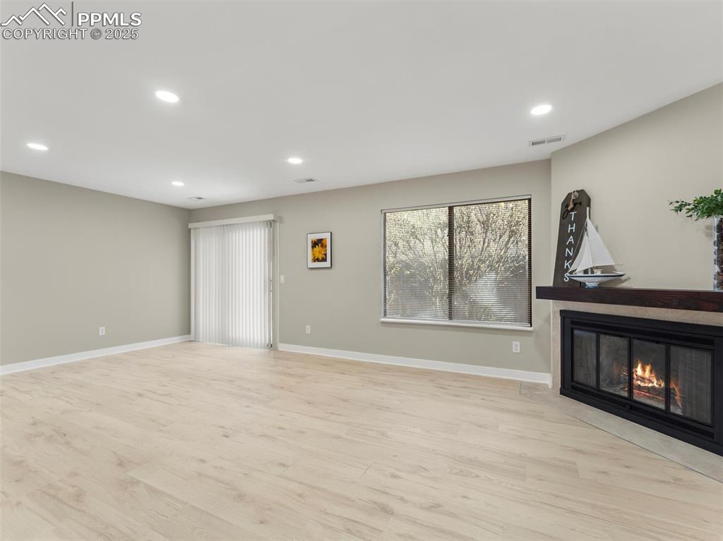 Image 7 of 36: Unfurnished living room featuring recessed lighting, light wood-style floor
