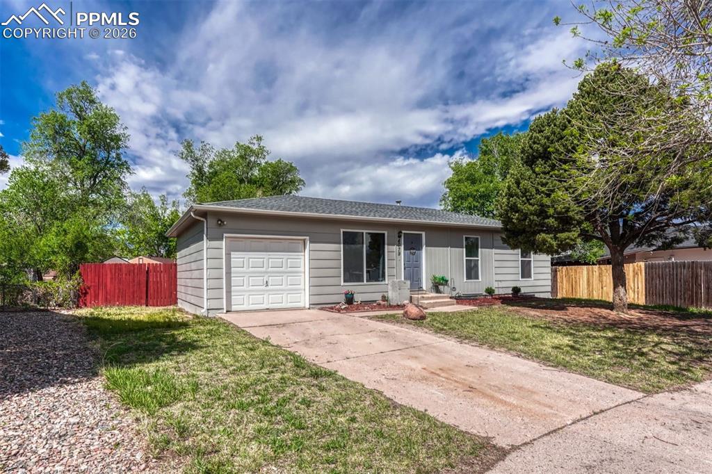 Image 1 of 42: Ranch-style residence featuring a light gray exterior, an attached garage, 
