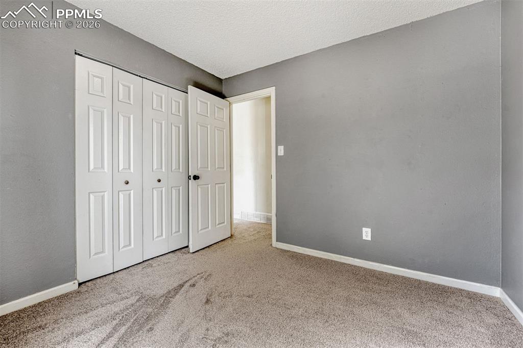 Image 17 of 42: Gray-painted interior featuring neutral carpeting and white trim