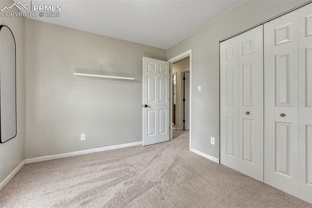 Image 19 of 42: Neutral-toned wall paint and textured carpeting define this room