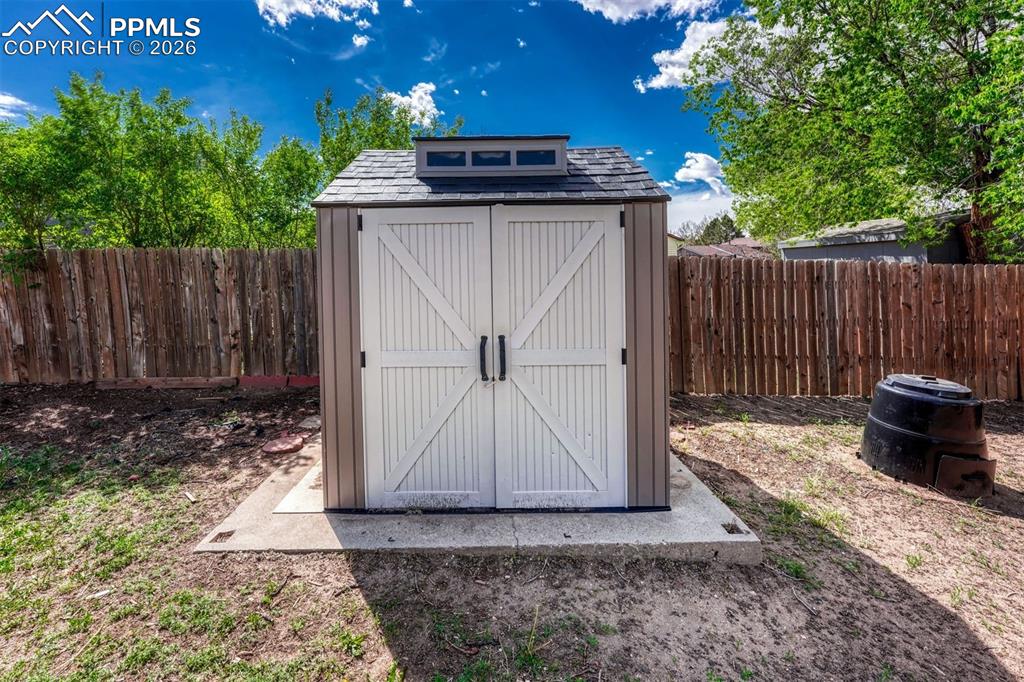 Image 36 of 42: Freestanding shed with double barn doors, a cupola with transom windows, an