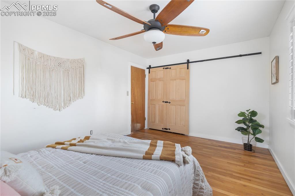 Image 19 of 35: Charming bedroom with modern ceiling fan