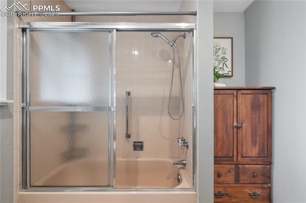 Image 22 of 35: Tub/shower combo with glass doors