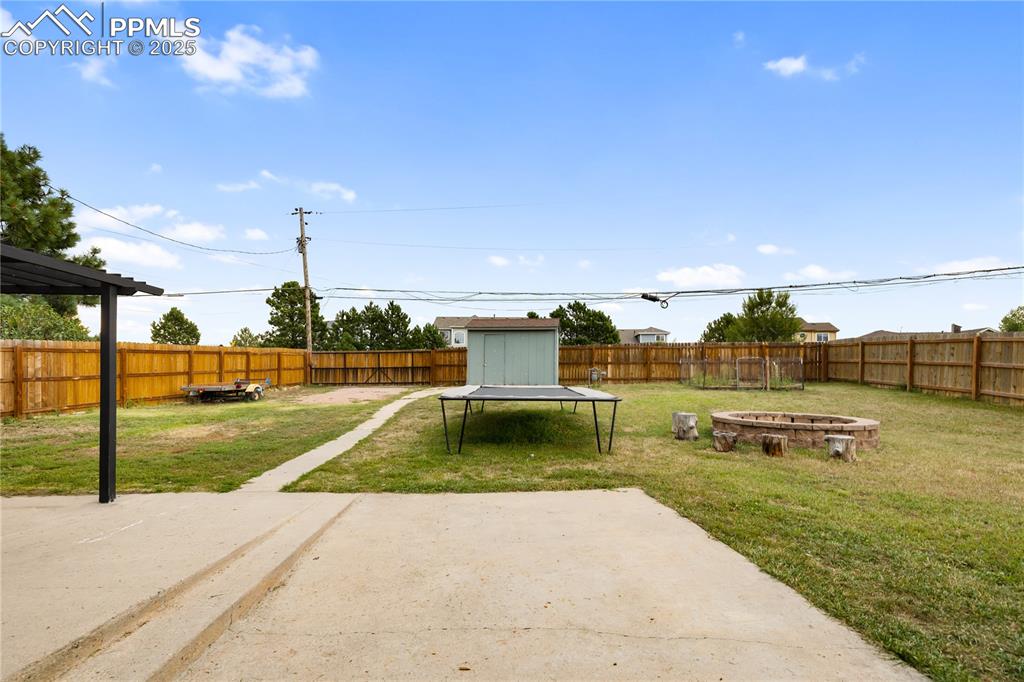 Image 29 of 35: Large fenced backyard with shed and access to the alley