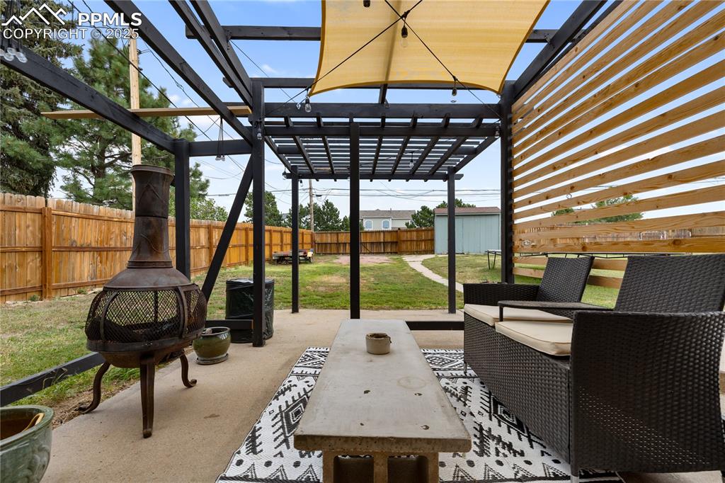 Image 31 of 35: Covered patio with pergola