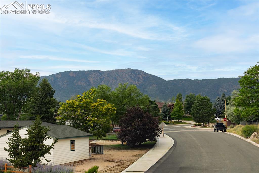 Image 35 of 35: Quiet street with mountain backdrop and small-town charm