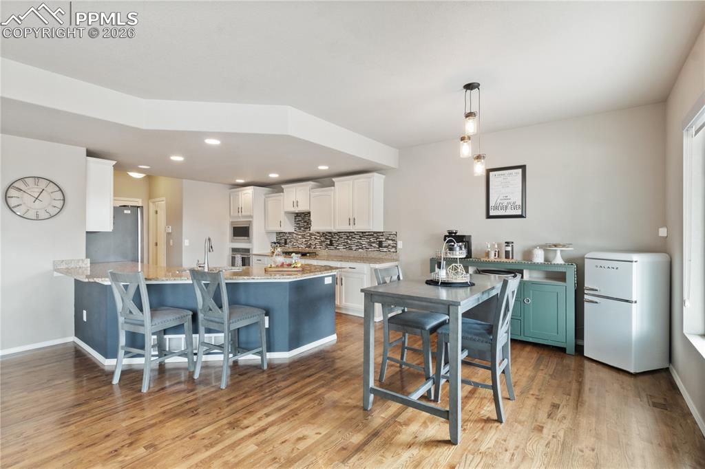 Image 17 of 50: Kitchen with a kitchen breakfast bar, a peninsula, stainless steel applianc