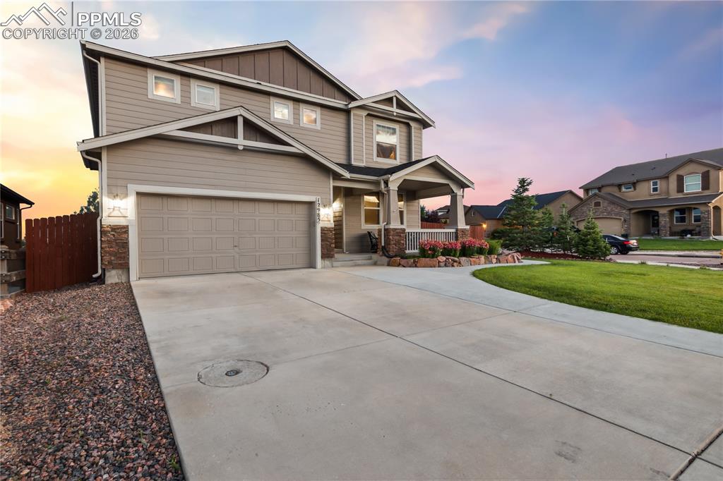 Image 2 of 50: Craftsman house featuring a porch, driveway, board and batten siding, a yar
