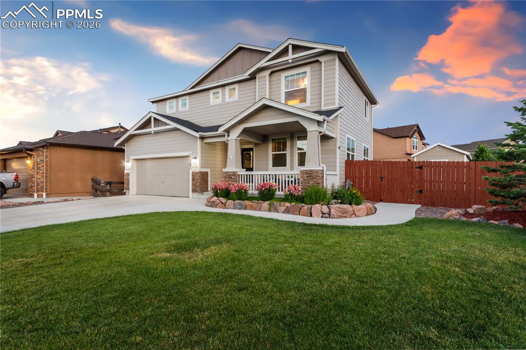 Image 3 of 50: Craftsman inspired home featuring a porch, driveway, a gate, and board and