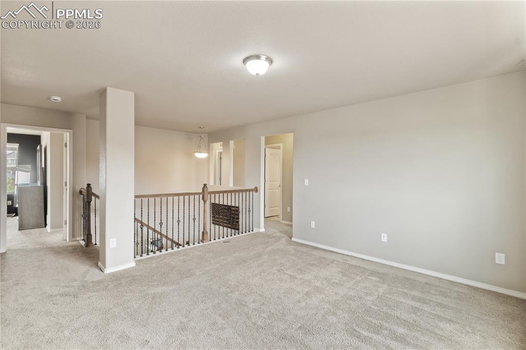 Image 31 of 50: Empty room with carpet floors and baseboards