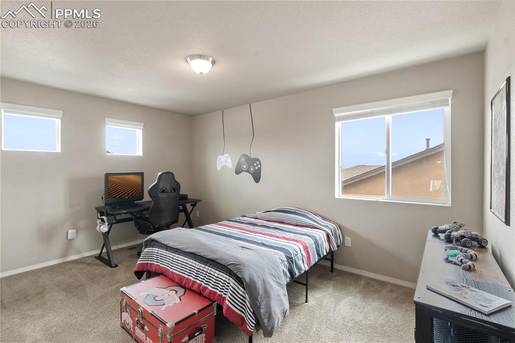 Image 32 of 50: Bedroom with light carpet and baseboards
