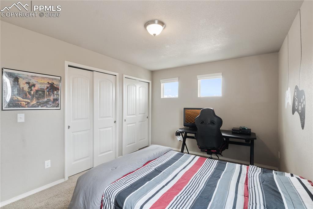 Image 33 of 50: Bedroom featuring carpet floors and multiple closets