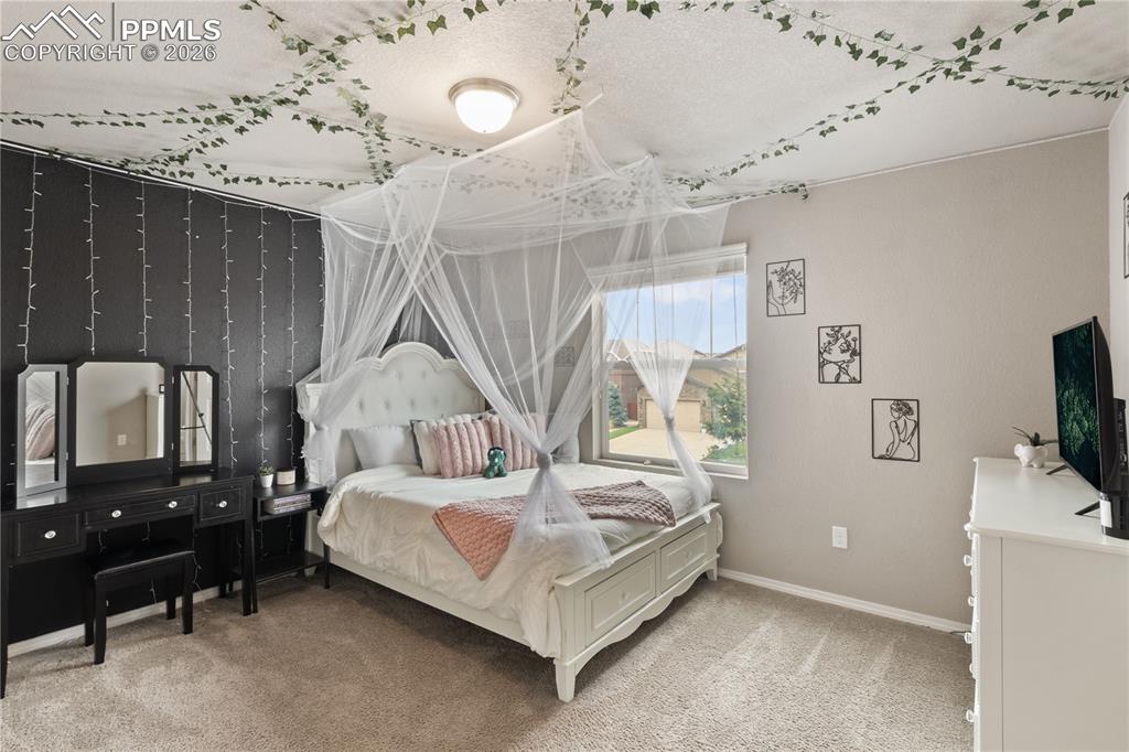 Image 37 of 50: Bedroom with light carpet and baseboards