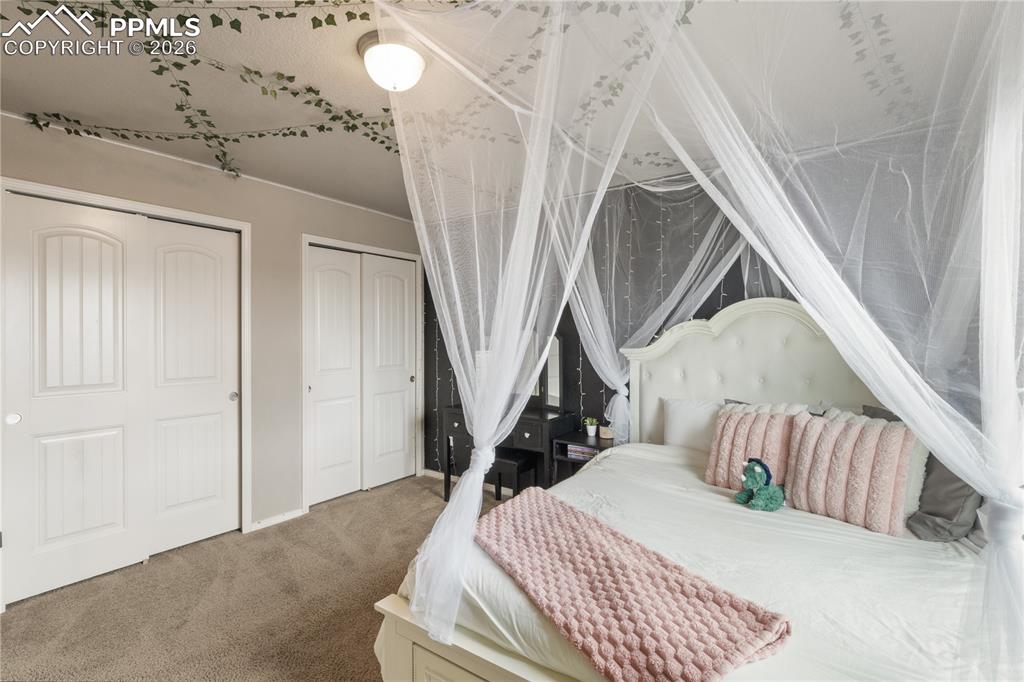 Image 38 of 50: Carpeted bedroom with multiple closets