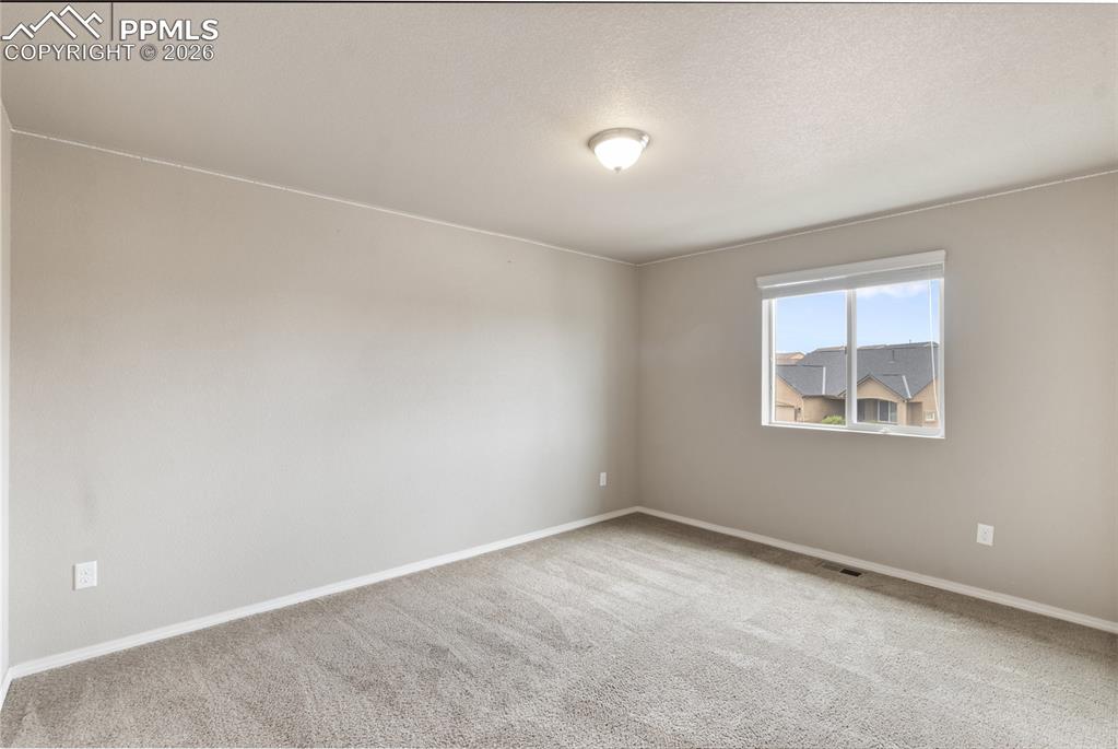 Image 40 of 50: Featuring light colored carpet and a textured ceiling