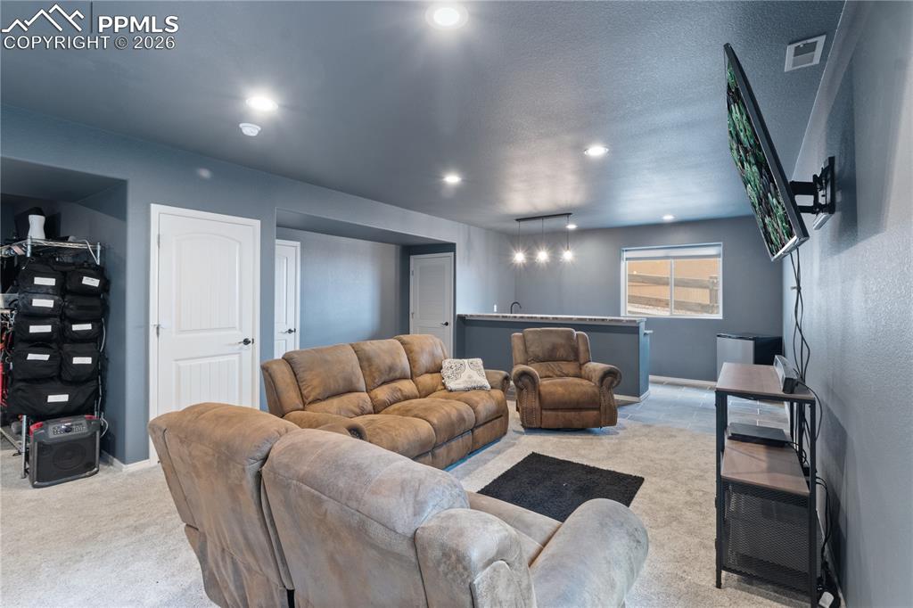 Image 48 of 50: 2nd Living room featuring recessed lighting and light carpet