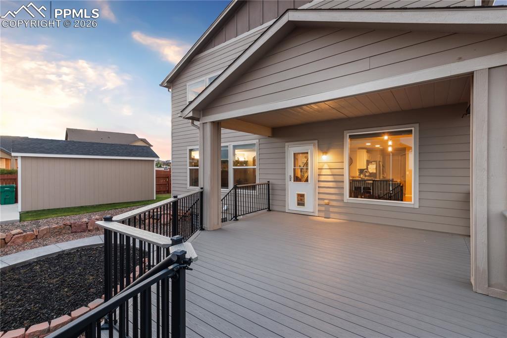 Image 5 of 50: Deck at dusk featuring an outbuilding