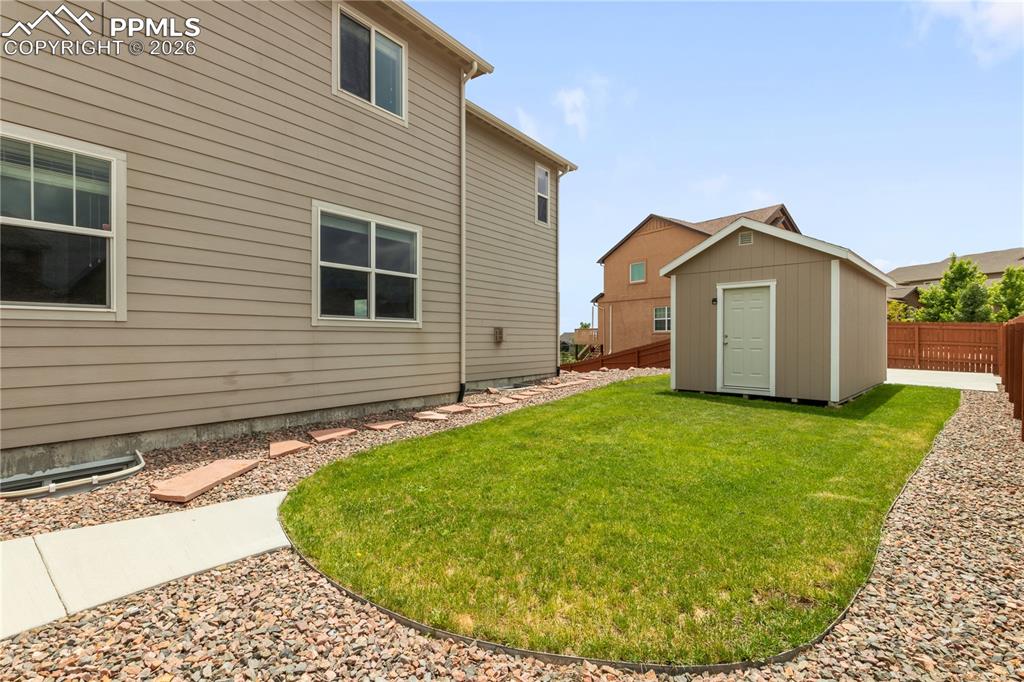 Image 50 of 50: Fenced backyard with a storage shed