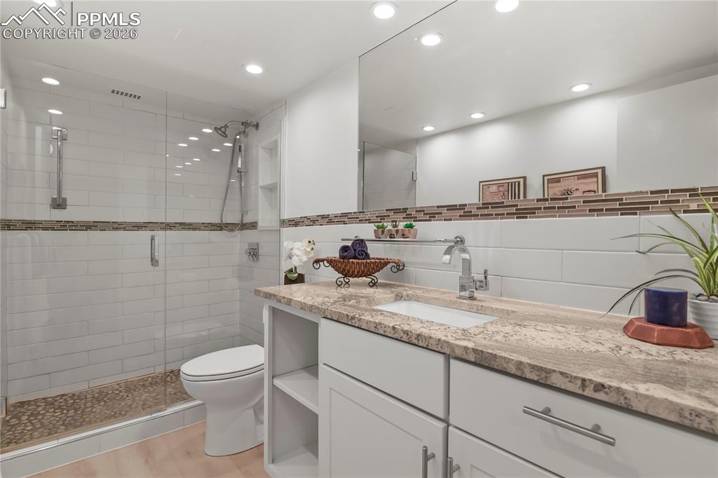 Image 15 of 30: a HUGE shower is the center of this bathroom. 