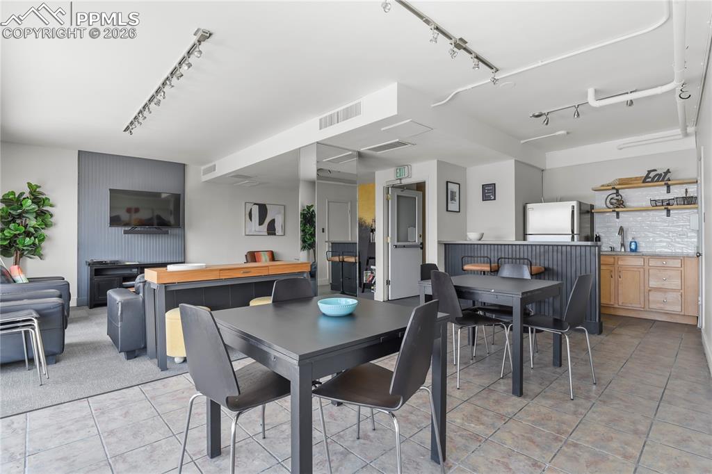 Image 27 of 30: the clubhouse has seating and a kitchenette for you to entertain large grou