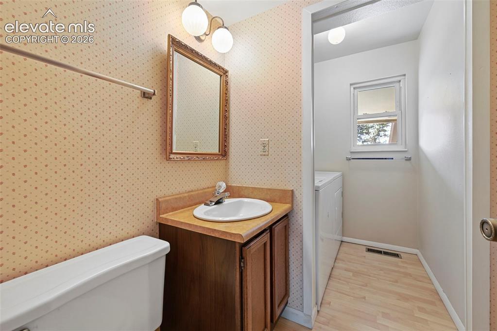 Image 12 of 24: Main level Bathroom with conveniently located washer and dryer