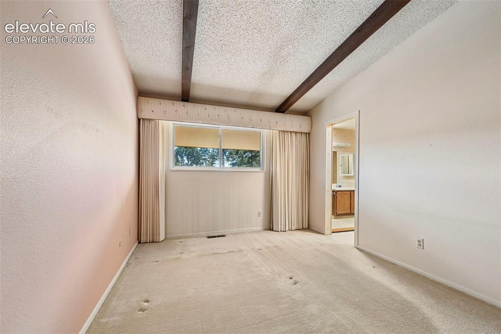 Image 16 of 24: Primary bedroom with private bath
