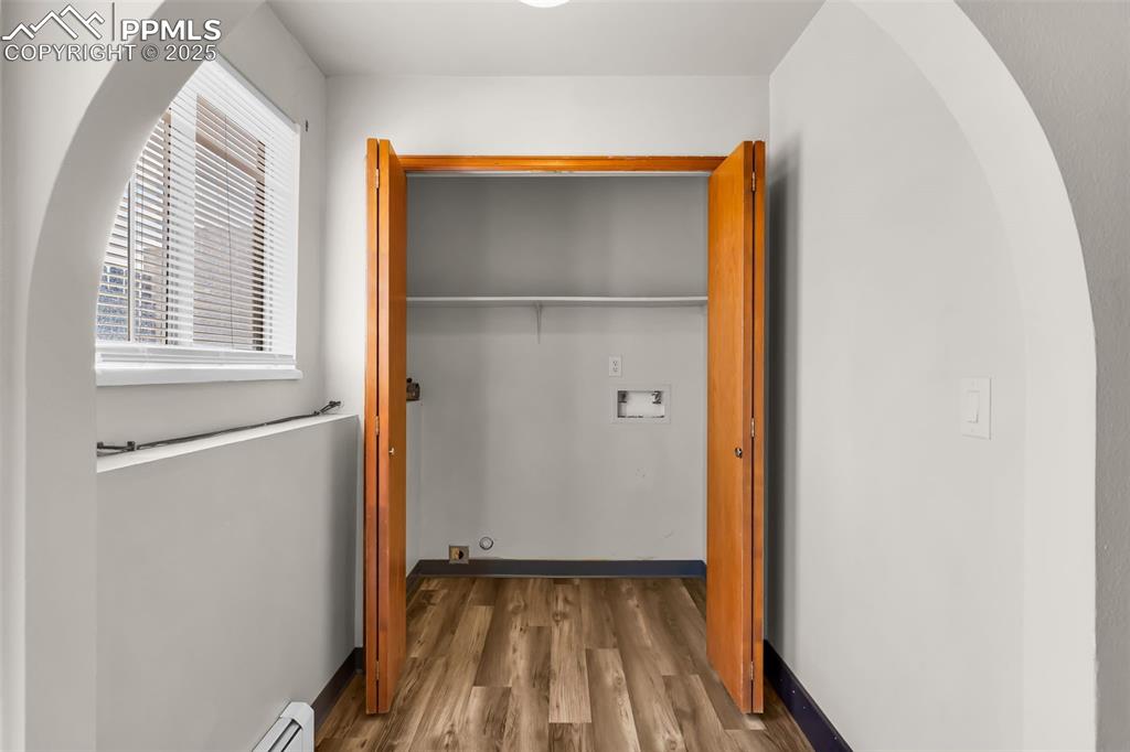 Image 20 of 26: Laundry closet featuring a baseboard heating unit