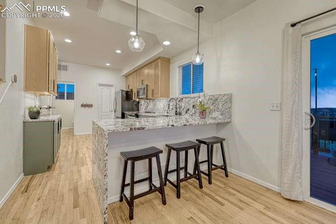 Image 11 of 44: Kitchen fully updated, new cabinets, new range, breakfast bar. 