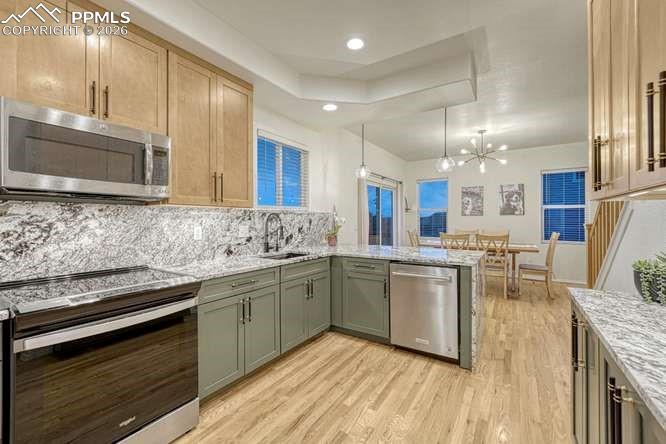 Image 12 of 44: Kitchen hardwood floor, new cabinets, new range. 